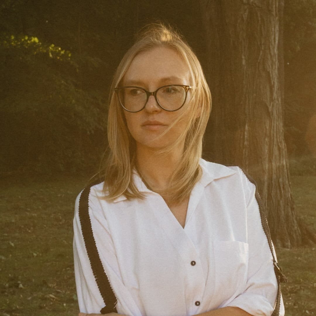 Viktoriia Nikitiuk, in a white shirt in golden-hour light